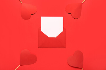 Composition with envelope, card and paper hearts on red background. Valentine's Day celebration