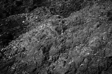 Weathered stone background. Black weathered rock.