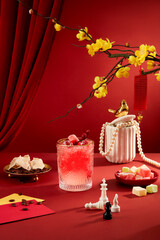 A striking glass of juice takes center stage on a red background, complemented by seahorse chess...