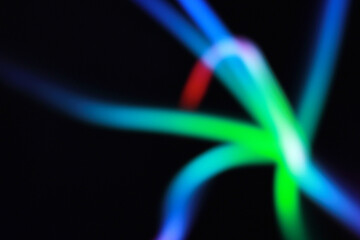 A blurry background of multi color spotlight in the dark 