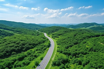 Fototapeta na wymiar Aerial view of asphalt road and green forest, Beautiful fresh green natural scenery of hilltop. Healthy environment. Natural landscape.