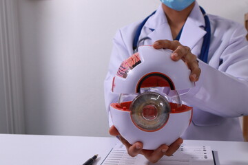 Close up of the ears of a professional female doctor in uniform taking notes in a notebook Medical therapist filling out medical documents. Clipboard. Patient form. Illness history, prescription