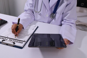 Close up of the ears of a professional female doctor in uniform taking notes in a notebook Medical...