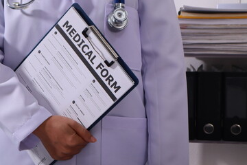 Close up of the ears of a professional female doctor in uniform taking notes in a notebook Medical...