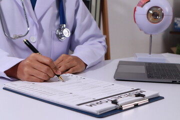 Close up of the ears of a professional female doctor in uniform taking notes in a notebook Medical...