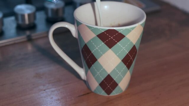 Argyle pattern ceramic mug on wooden countertop