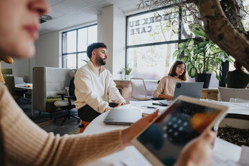 Employees brainstorm and discuss ideas for business growth in a collaborative and creative office environment.