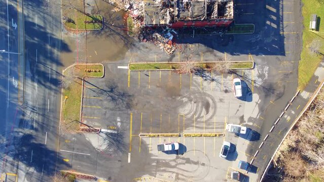 Drone Following Street Sweeper Circling Mess Outside of Demolished Building