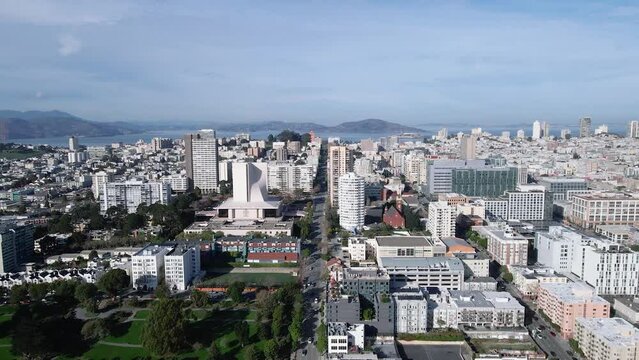 Drone footage capturing the striking Cathedral of Saint Mary of the Assumption in San Francisco. The modern architecture stands out against the city backdrop