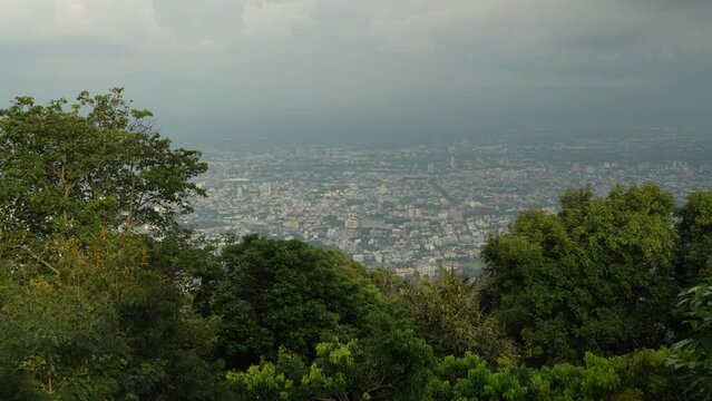 High angle shot of Chiang Mai city visible from Doi Suthep viewpoint in Chiangmai, Thailand on a cloudy day.