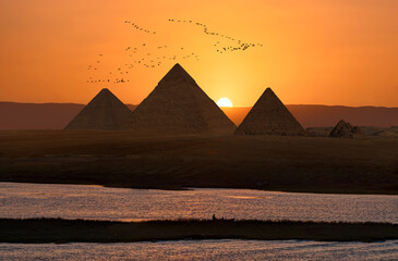 Giza pyramid Complex in Aswan city by the Nile at amazing sunset - Egypt