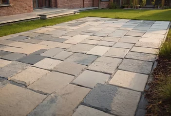 Foto op Plexiglas Laying gray concrete paving slabs in house courtyard driveway patio. Professional workers bricklayers are installing new tiles or slabs for driveway, sidewalk or patio on leveled sand foundation base. © Алексей Ковалев