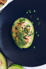 Healthy salad with avocado, smoked salmon, green onion and dill