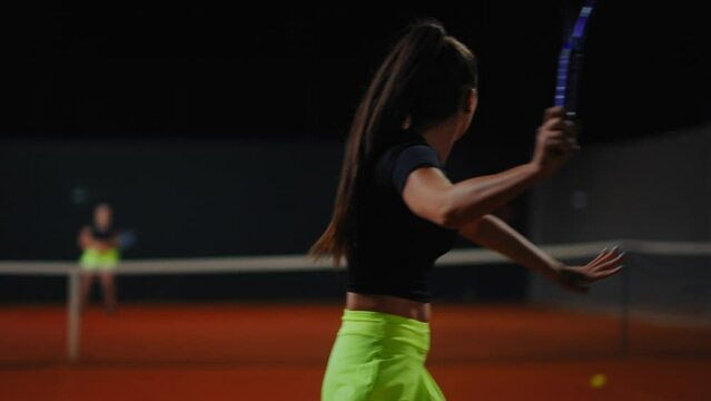 Women Playing Tennis On Court In Night, Active Hobby And Sport, Back View Of Athletic Lady
