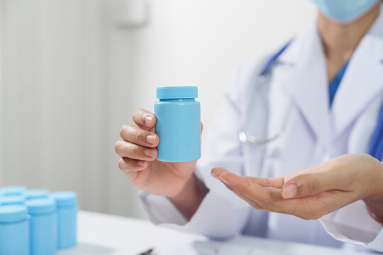 Specialist medical professionals check the quality and expiration date of the vials and medicine capsules.