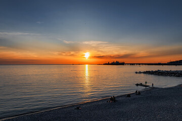 An impressive colorful sunset sky over the Black Sea. Natural background with clouds. Sunset view over the calm sea. Dramatic magical seascape at sunset in the Black Sea.