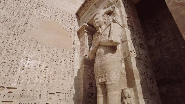 Luxor, Egypt - November 26 2023: The Ramessid columns in the peristyle court of the famous temple of Ramesses III in Medinet Habu on Luxor near the Valley of Kings in upper Egypt. 