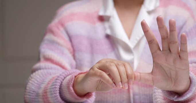 Woman hand has office syndrome and relaxation arthritis with self-massage stretching finger reflexology.