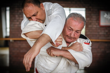 Close-up portrait of judo sensei master instructor in traditional gi kimono demonstrate judo...