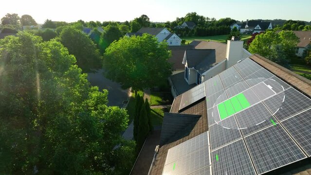 Solar panel with charging battery animation during bright sunset. 3D render on aerial shot of photovoltaic array on American residential rooftop. Renewable, green energy in futuristic neighborhood.