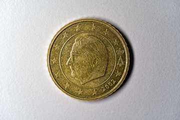 Close-up of golden Euro Cent coin value 50 cents against gray background. Photo taken December...