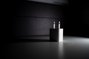 Cube-shaped charger illuminated with dramatic lighting.