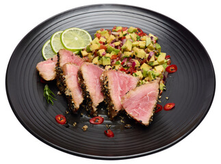Sliced Organic grilled Tuna fillet covered with sesame seeds and salsa on black ceramic plate