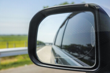 View of the toll road in the car's side mirror