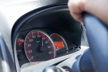 Modern car speedometer shows high driving speed