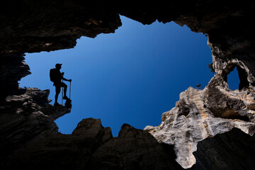 Discovery of new caves by a professional mountaineering explorer - obrazy, fototapety, plakaty