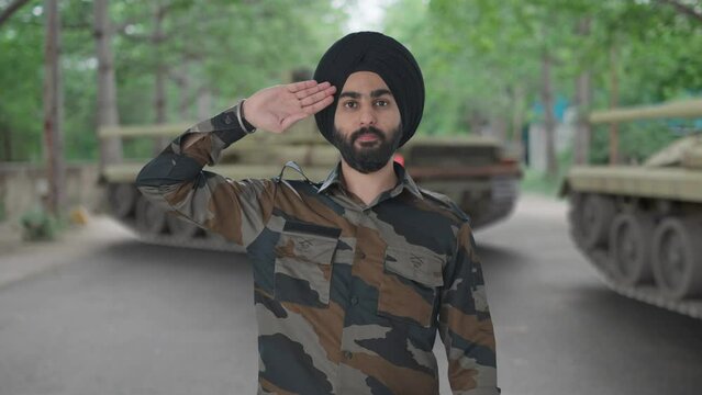 Confident Sikh Indian Army man saluting to the Indian flag