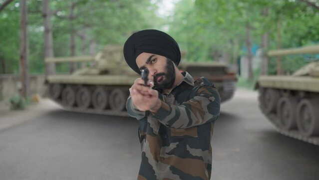 Serious Sikh Indian Army man pointing gun towards enemy