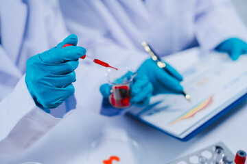 Professional scientists in lab working with blood samples. to find components in blood Ideas for inventing and researching drugs and viruses in blood system.