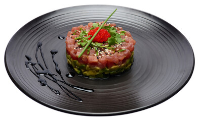 Tuna and avocado tartare on a dark ceramic plate
