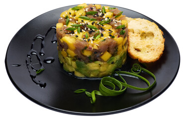 Traditional tuna and mango tartare on black ceramic plate