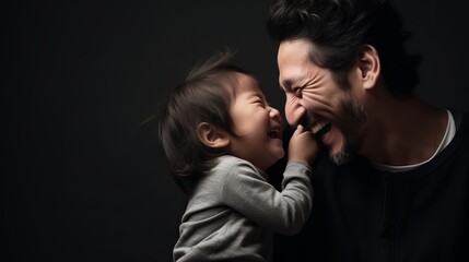 Laughing Together: A Joyful Father-Son Portrait in a Black Studio Background on Father's Day