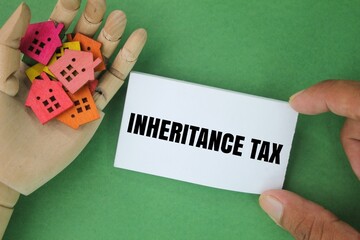 house shape and white paper with the words Inheritance Tax. concept of inheritance tax - obrazy, fototapety, plakaty