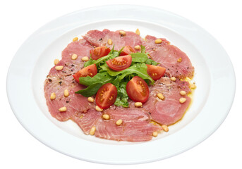 cooking tuna carpaccio - Fresh raw tuna fillet with olive oil and pine nuts on white ceramic plate