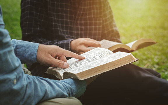 Bible Study IdeasChristian Life A group of Christian friends sat at an outdoor Bible study in a park and prayed together and lived God's Word. Sunday Bible study