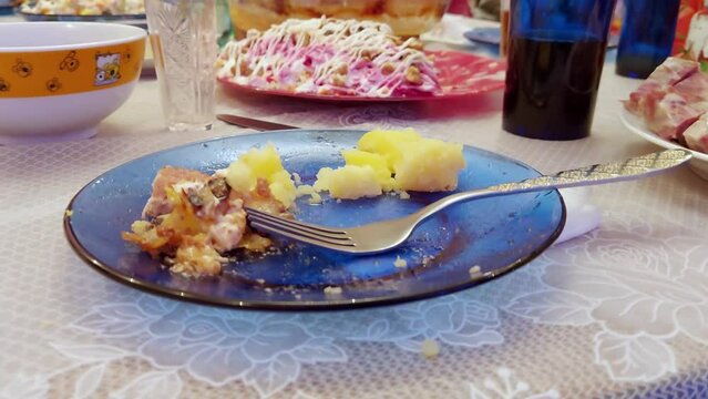 Leftover food sits on a plate during the holiday meal, close-up