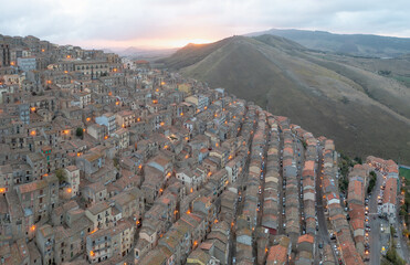 The stunning village of Gangi with Mount Etna volcano at its back in Sicily, Italy. Panoramic aerial view of the houses. One of the most beautiful towns in Sicily. The winding streets of the old town.