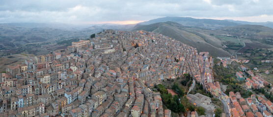 The stunning village of Gangi with Mount Etna volcano at its back in Sicily, Italy. Panoramic aerial view of the houses. One of the most beautiful towns in Sicily. The winding streets of the old town.