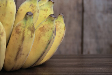 Banana fruit with wooden on blurred background