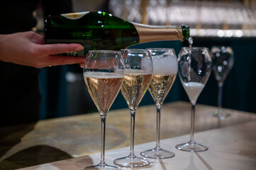 Tasting of sparkling wine champagne on winter weekend festival in December on Avenue de Champagne,...