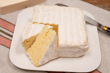 French squared pont l'eveque cow cheese from Calvados department, close up, Pont l'eveque village, Normandy, France