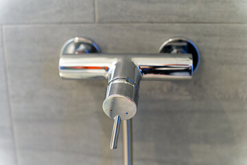 Bathroom of apartment building with close-up shower mixer at Swiss City of Zürich. Photo taken...