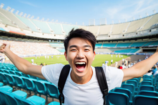 Portrait of Asian teenager is excited and happy about the victory of his favorite football team