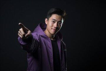 a handsome asian man pointing forward
