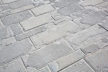 Wandcirkels aluminium Old and damaged italian paving made with chiseled grey sandstone blocks in a pedestrian zone - The surface part is being damaged due to the freeze and thaw cycles that break the stone © Francesco Scatena