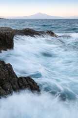 Cliffs with waves on the Mediterranean coast. Sicily, Italy.
Beautiful weather. Traveling concept background.